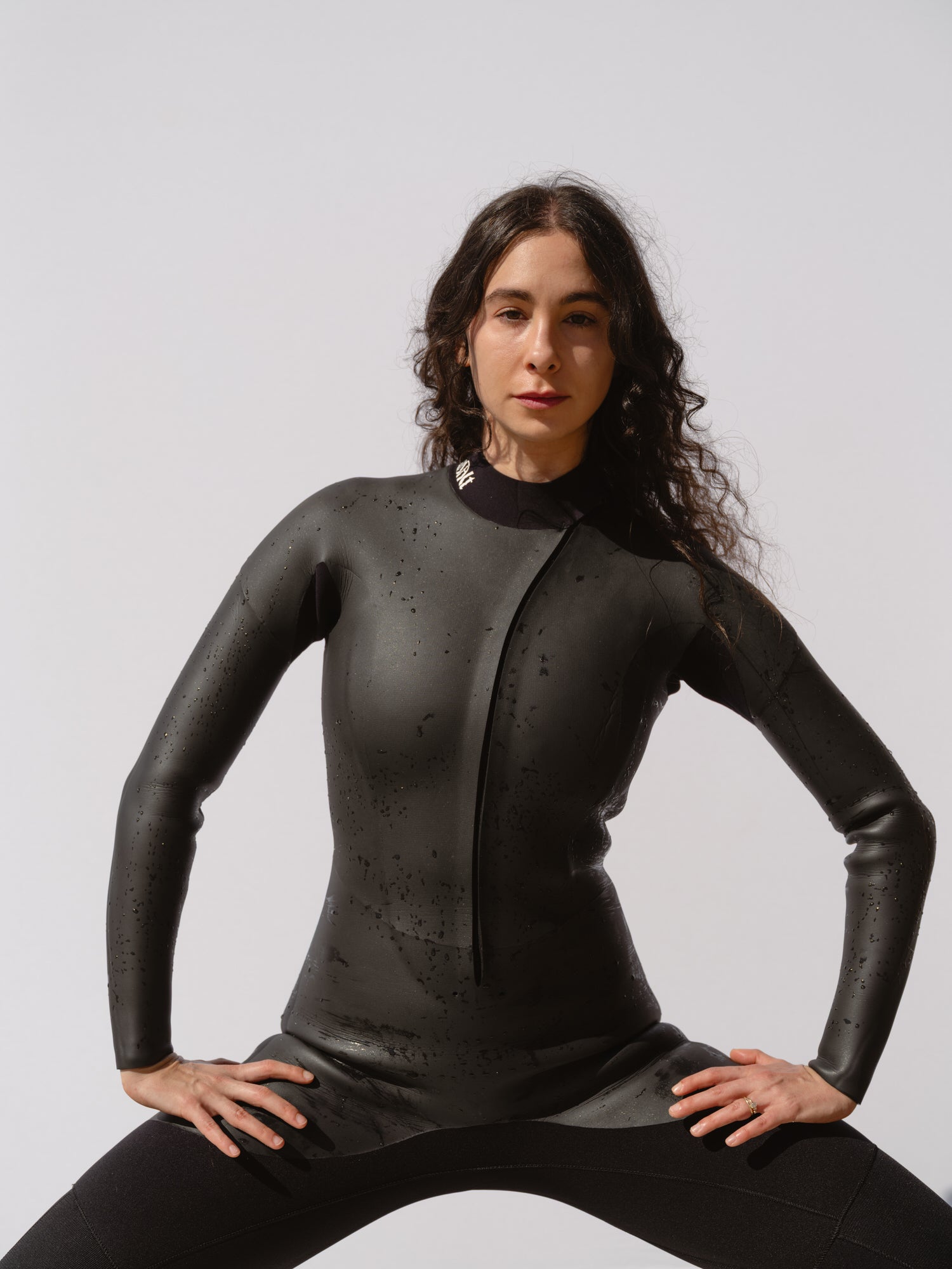 Woman in a Basalt women’s 4/3mm Smoothskin wetsuit with curved front zip and smoothskin chest panel