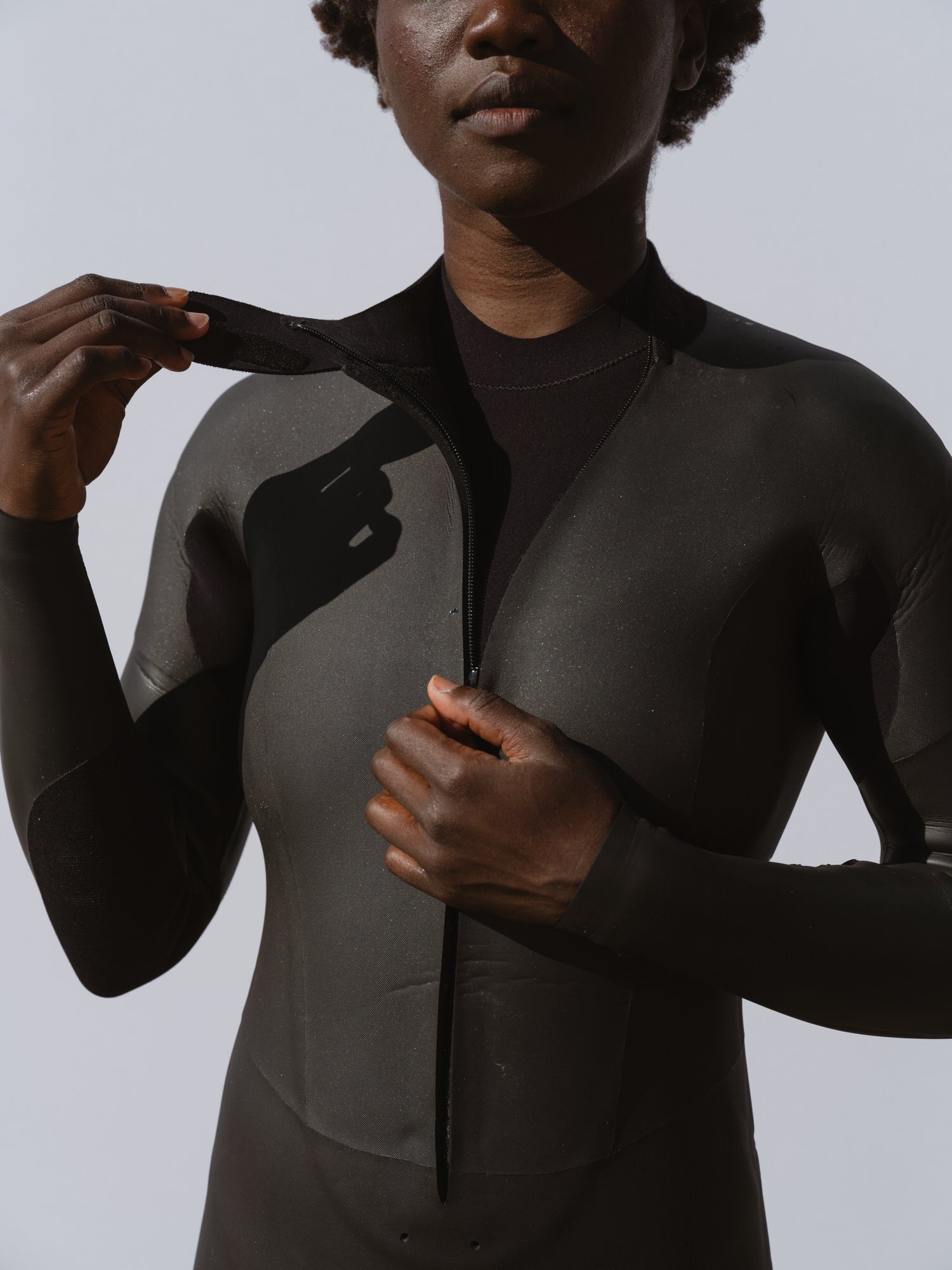 Detail of curved chest zip on Basalt women’s Smoothskin 4/3mm wetsuit